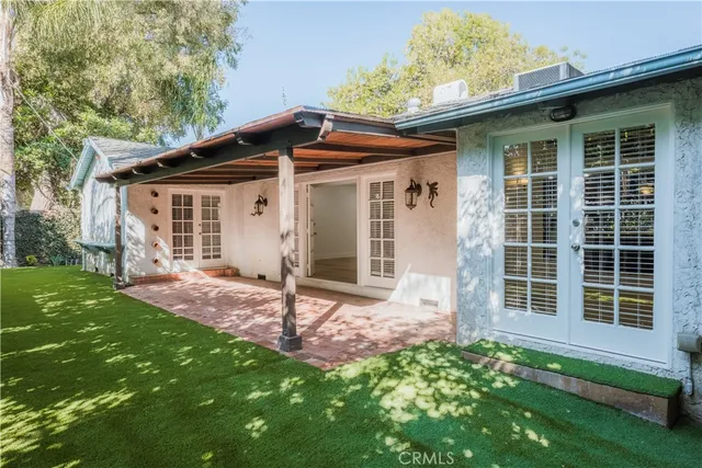 a view of a house with a yard and porch