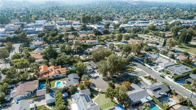 an aerial view of a house with yard swimming pool and outdoor seating