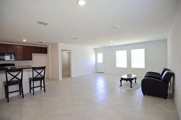 a view of a livingroom with furniture and a window