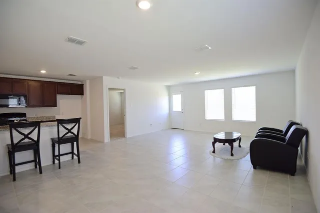 a view of a livingroom with furniture and a window