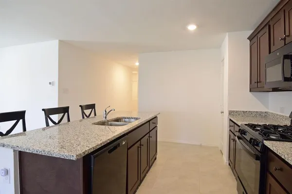 a kitchen with granite countertop cabinets and stove