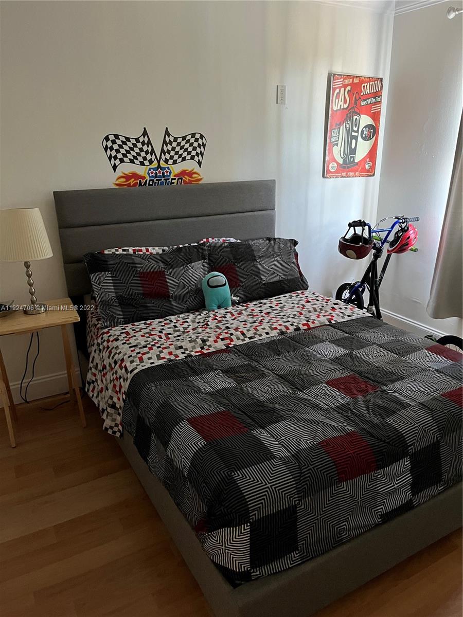 255 Galen Drive, Unit 2I Key Biscayne, FL 33149 - Photo 13 of 14 a bed sitting in a bedroom next to a lamp