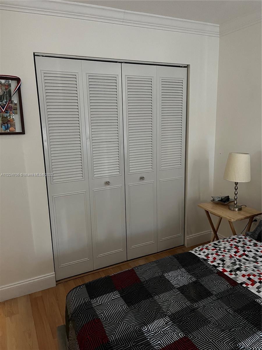 255 Galen Drive, Unit 2I Key Biscayne, FL 33149 - Photo 14 of 14 a bedroom with a bed and a table in it