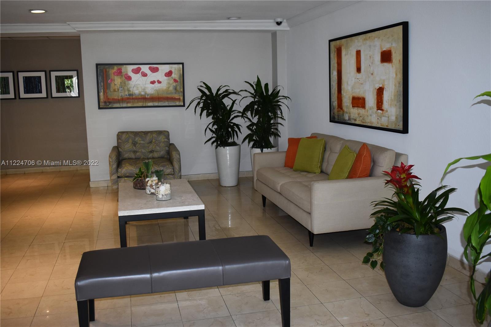 255 Galen Drive, Unit 2I Key Biscayne, FL 33149 - Photo 2 of 14 a living room with furniture potted plant and a couch