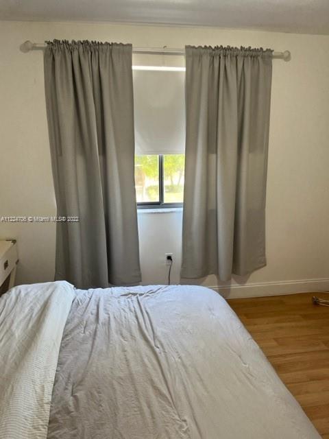 255 Galen Drive, Unit 2I Key Biscayne, FL 33149 - Photo 9 of 14 a bedroom with a bed and a window