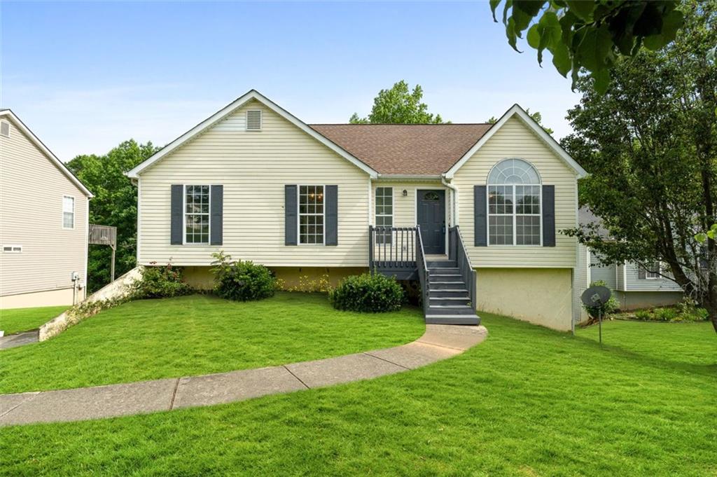 a front view of a house with a yard