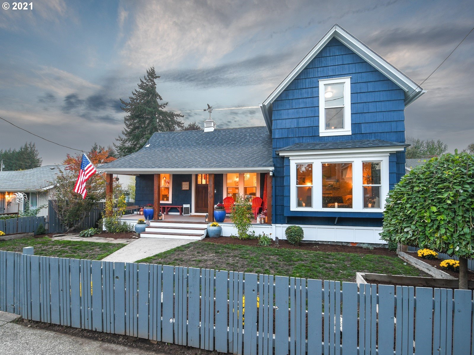 a front view of house with yard and outdoor seating
