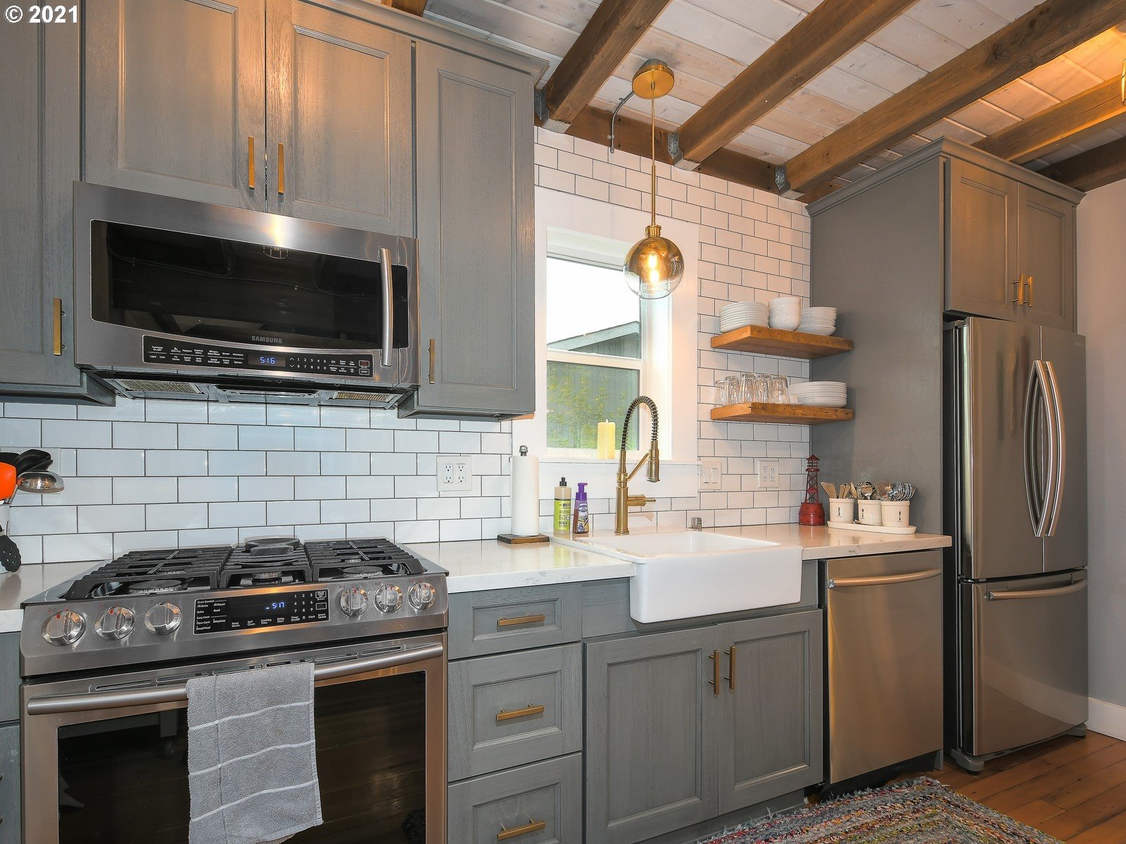 115 South 4th Avenue Ridgefield, WA 98642 - Photo 10 of 32 a kitchen with a sink stove and refrigerator