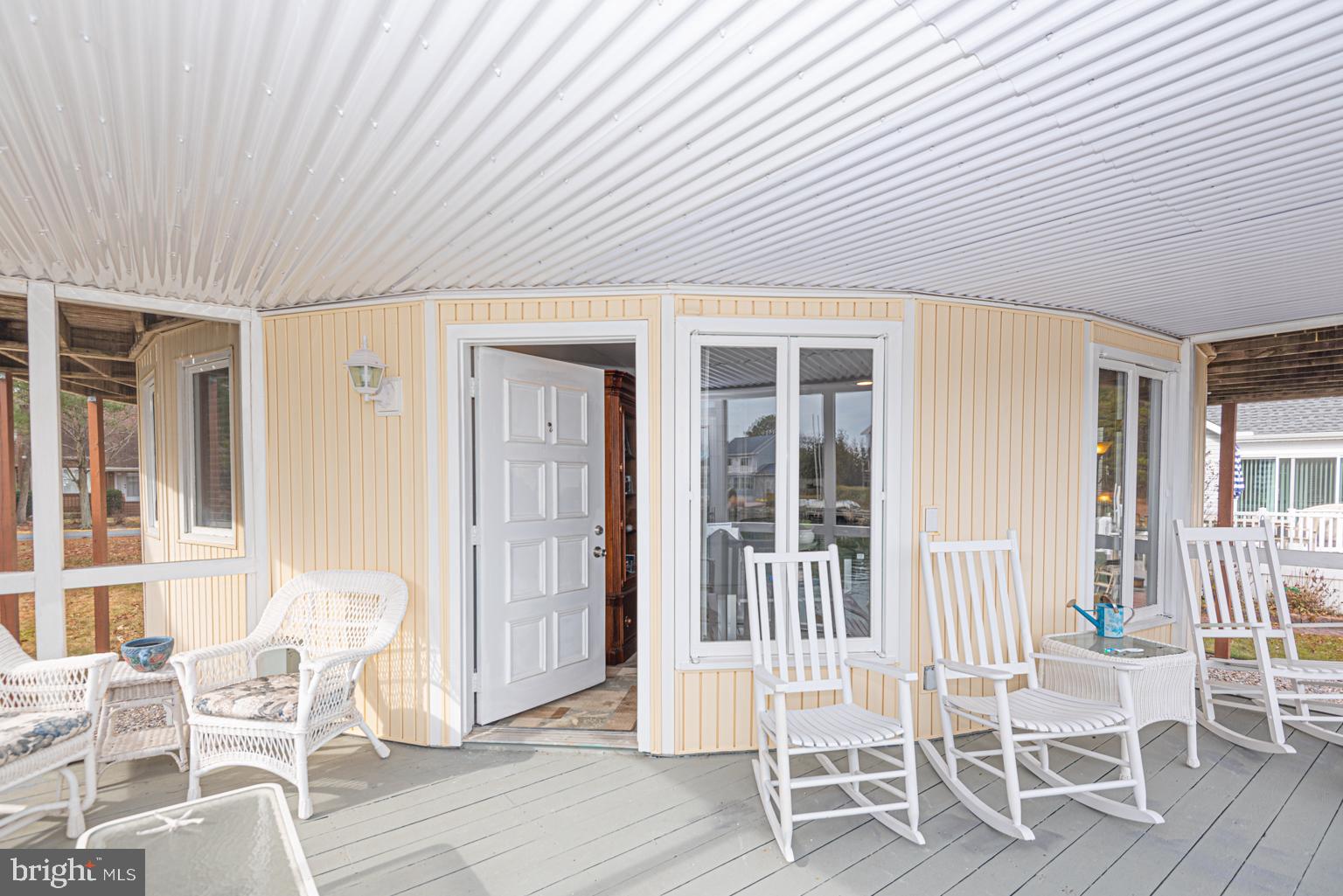 116 Watertown Road Ocean Pines, MD 21811 - Photo 55 of 78 a patio with table and chairs and potted plants