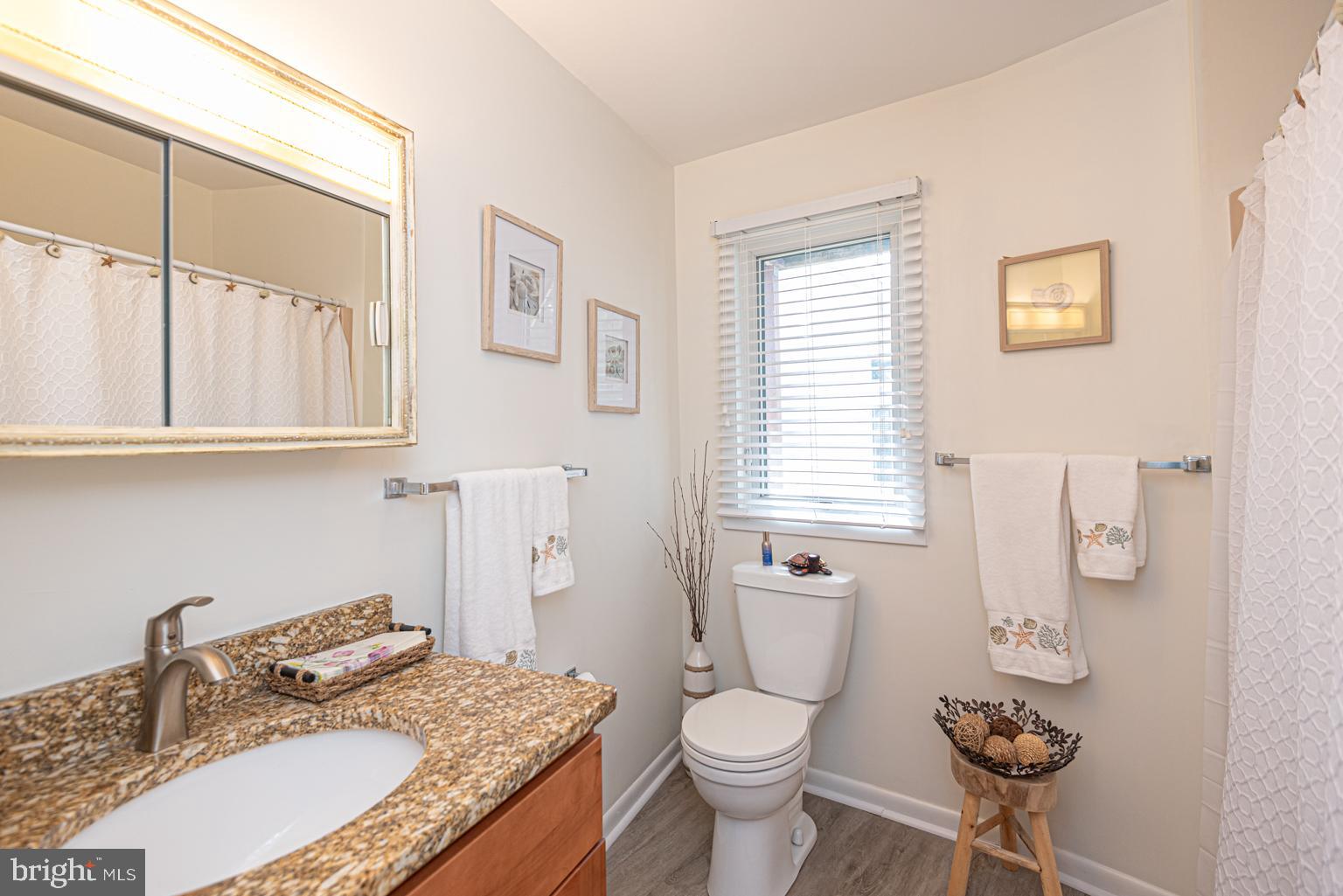 116 Watertown Road Ocean Pines, MD 21811 - Photo 60 of 78 a bathroom with a granite countertop toilet a sink and a mirror