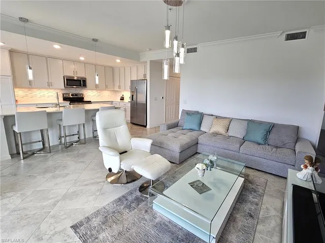a living room with furniture a flat screen tv and a large window