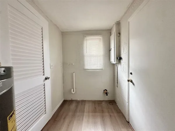 an empty room with wooden floor and closet
