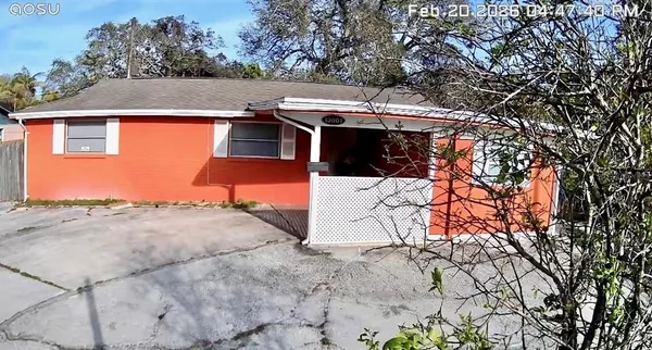 a kitchen with stainless steel appliances kitchen island granite countertop a refrigerator a sink dishwasher a stove and a wooden cabinets