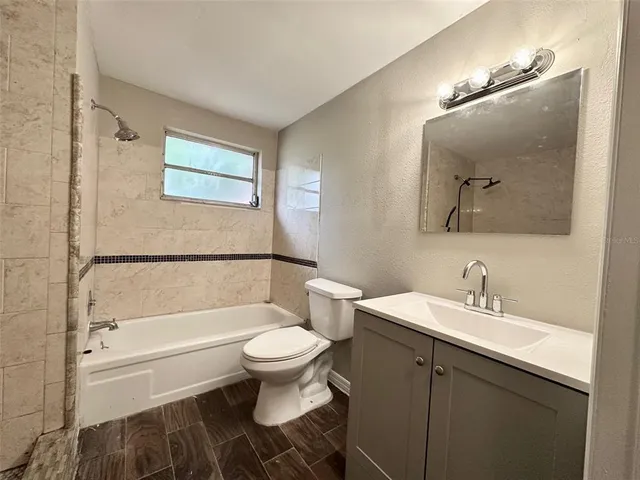 a bathroom with a toilet a sink and bathtub