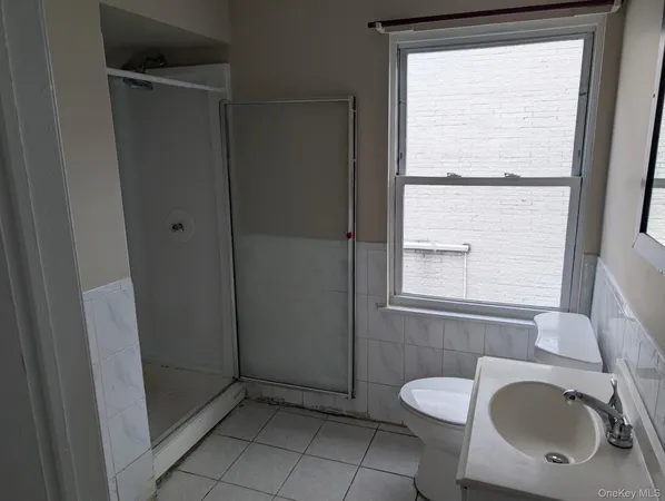 a bathroom with a toilet sink vanity and mirror