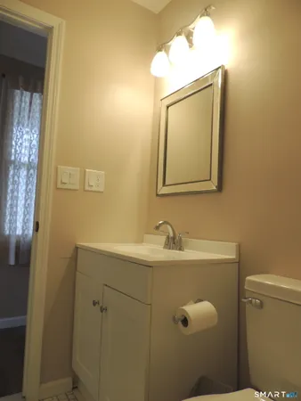 a large bed sitting in a bedroom next to a window and a bathroom