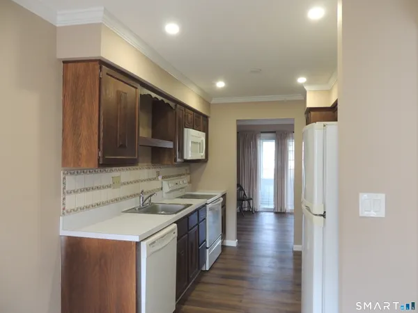 a kitchen with a sink and a refrigerator