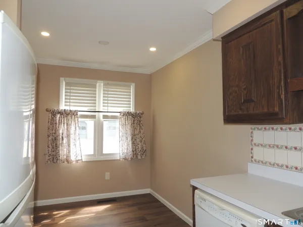 a view of a room with wooden floor and cabinet