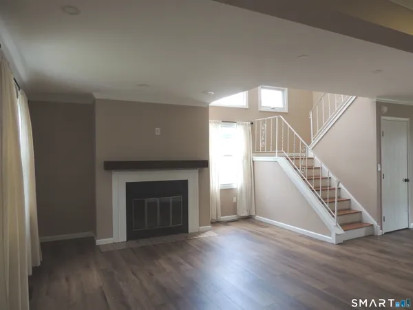 a view of an entryway with wooden floor