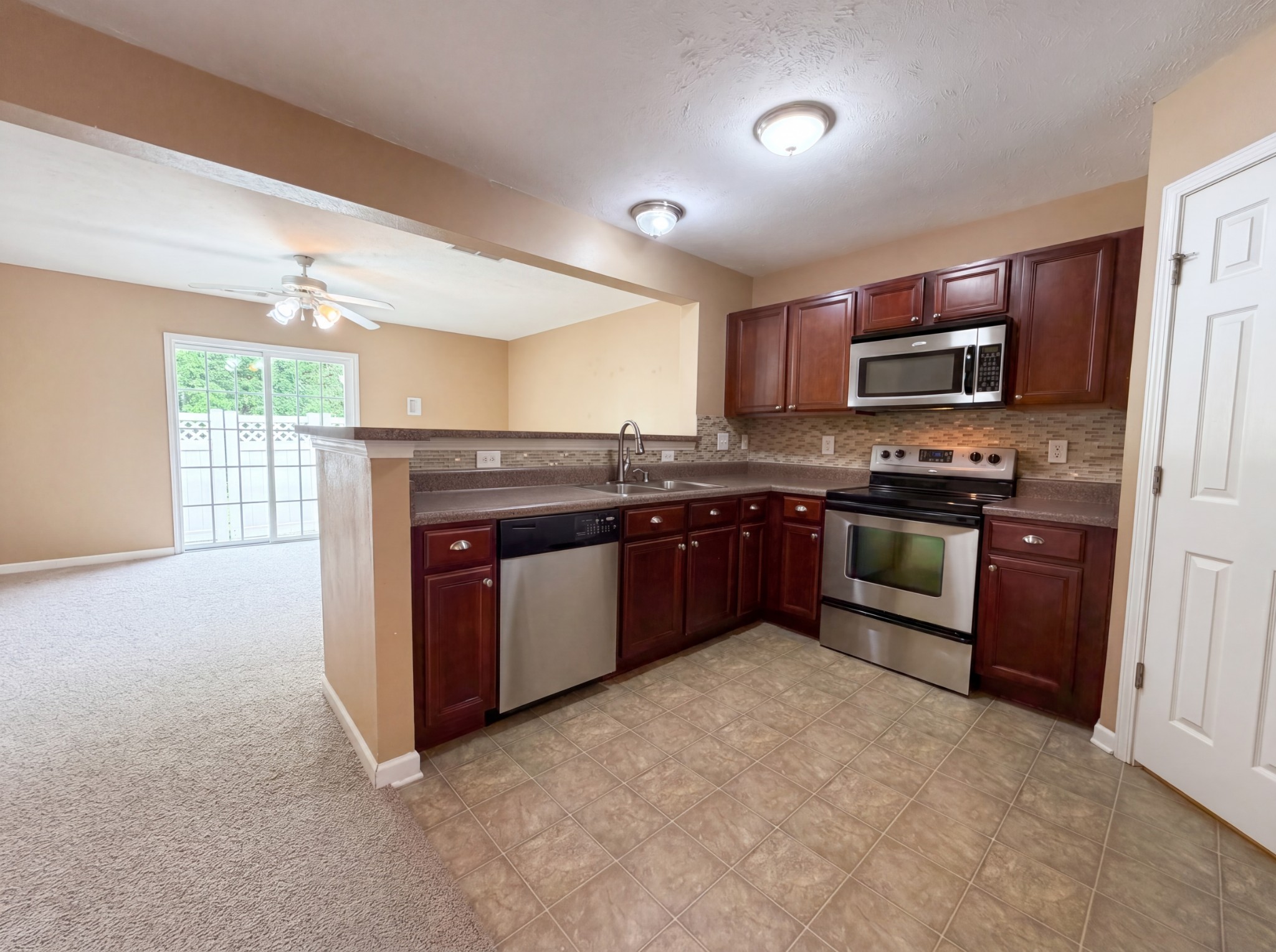 2032 Shaylin Loop Antioch, TN 37013 - Photo 5 of 15 a kitchen with stainless steel appliances granite countertop a stove cabinets and a refrigerator
