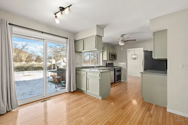 a kitchen with white cabinets and appliances