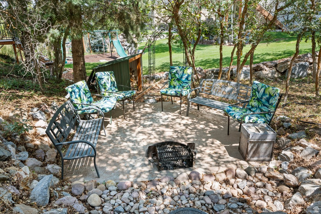 288 South Hillside Drive Elk Ridge, UT 84651 - Photo 23 of 27 Private and secluded firepit with woodshed and waterfall