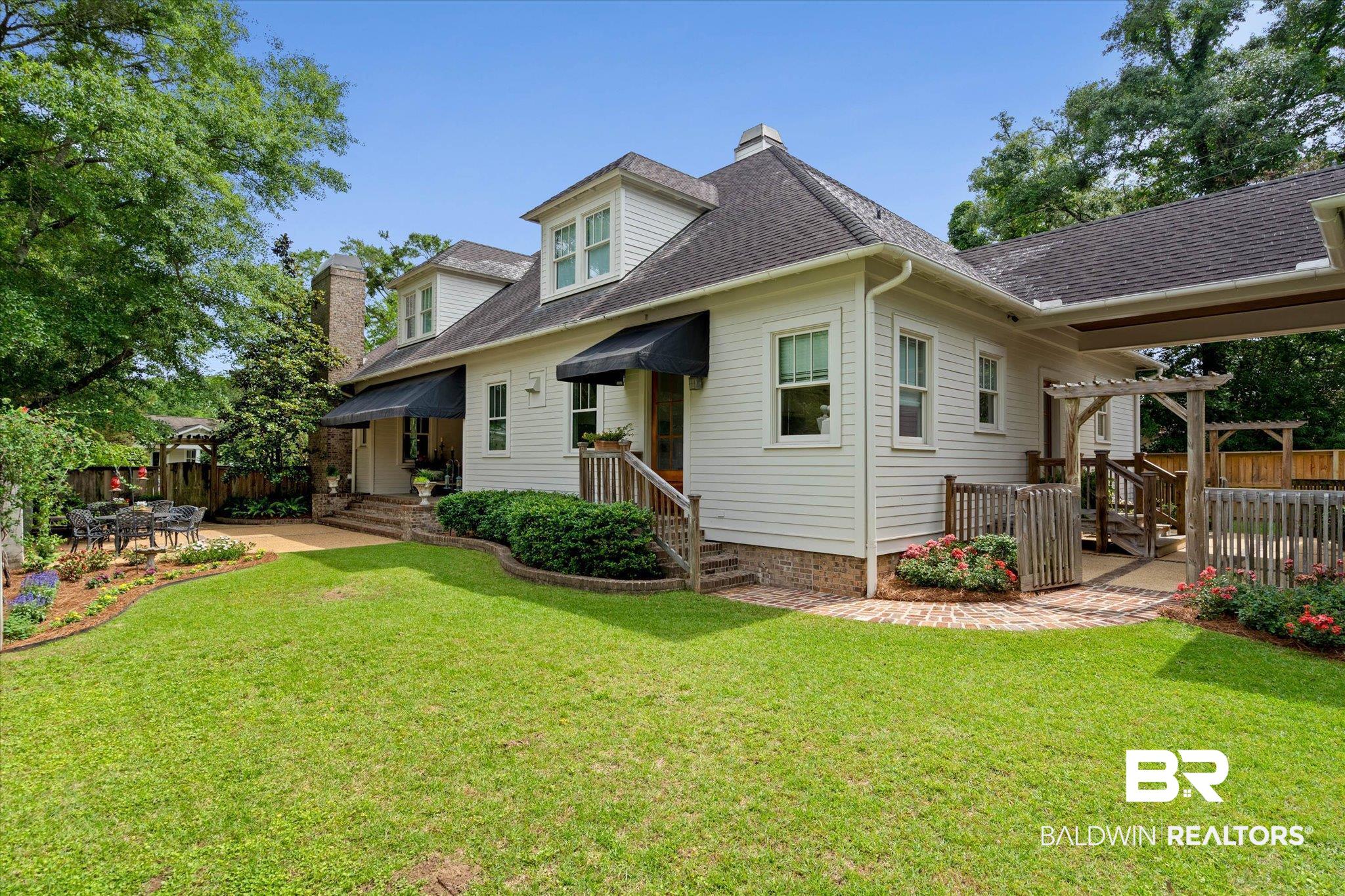 3813 Austill Lane Mobile, AL 36608 - Photo 30 of 37 Expansive green lawn with established landscaping beds, a sizable patio, and a covered pergola