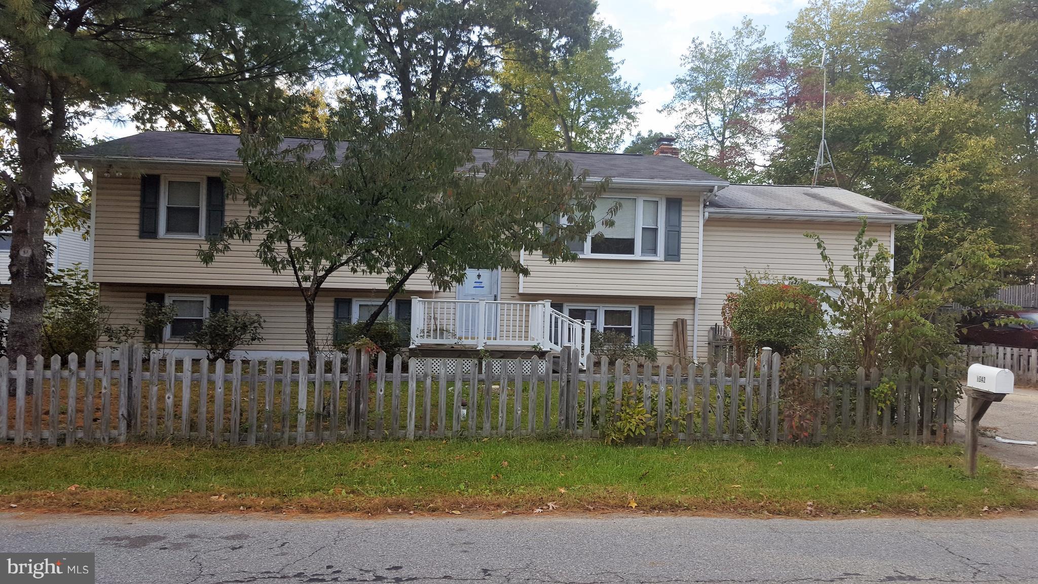 a house that has a tree in front of it