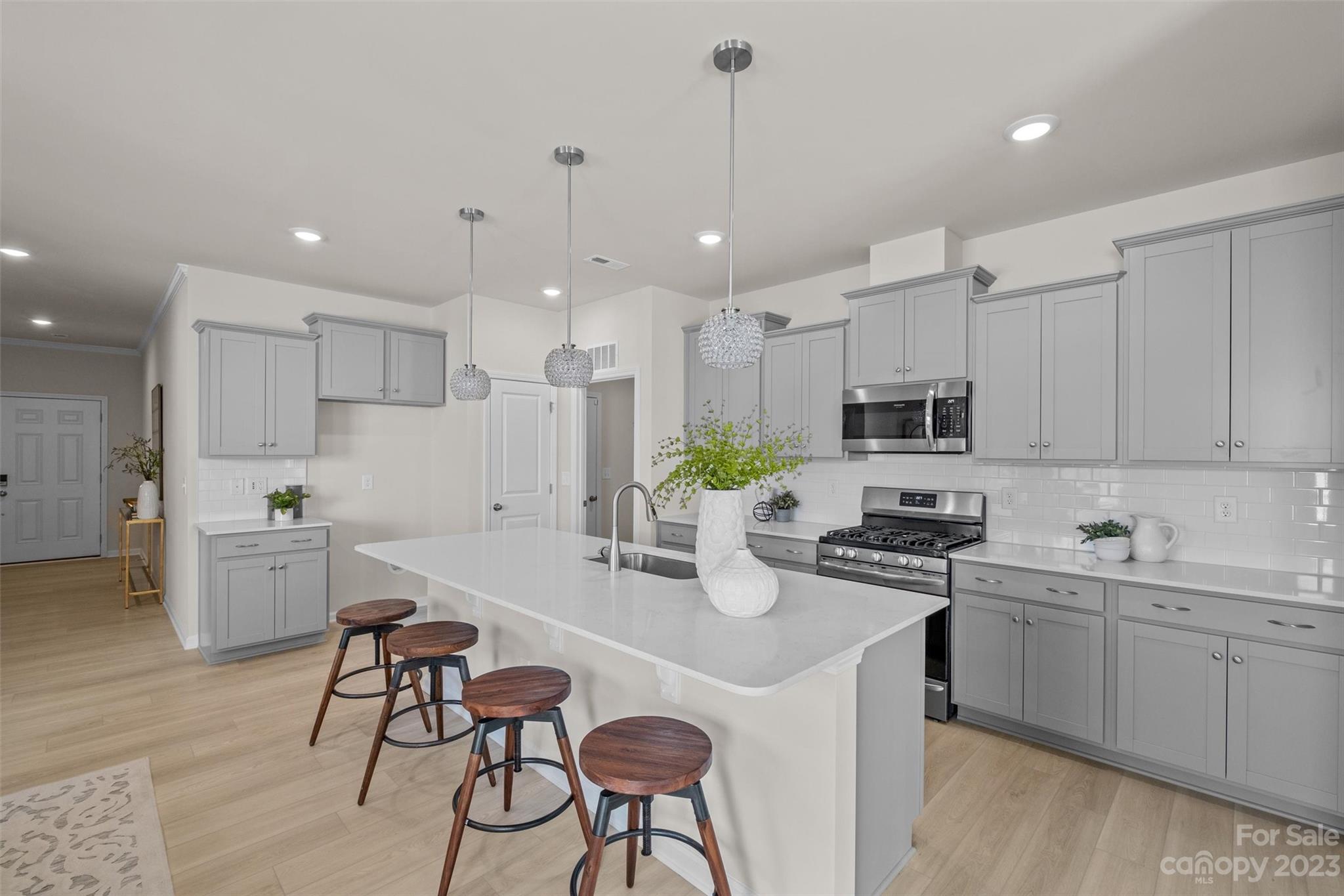 6577 Gopher Road Lancaster, SC 29720 - Photo 7 of 37 a kitchen that has a lot of cabinets in it with stainless steel appliances granite countertop a sink a stove a dining table and chairs