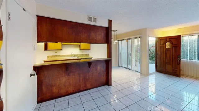 a view of an empty room with wooden floor and closet