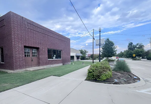 a front view of a house with a garden and yard