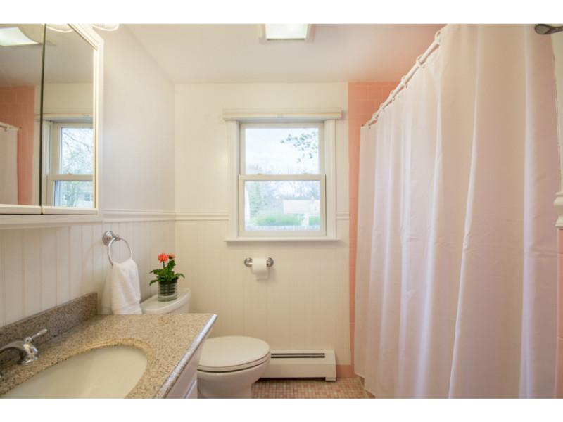 Bathroom. The full bath on the main floor has original tile floors with a fresh paint job brining this retro bathroom right into 2015 with flair!