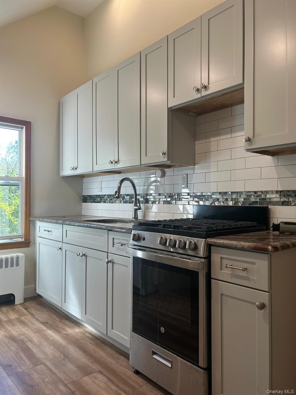 42 Park Avenue, Unit 3 Suffern, NY 10901 - Photo 5 of 13 a kitchen with granite countertop white cabinets and white appliances