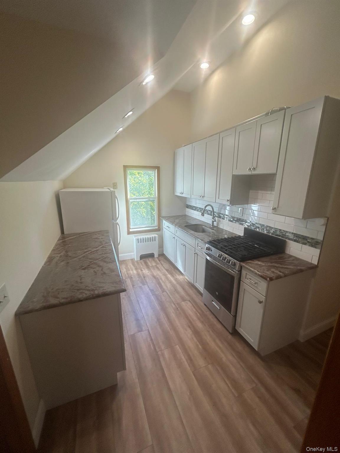 42 Park Avenue, Unit 3 Suffern, NY 10901 - Photo 6 of 13 a kitchen with granite countertop wooden floors appliances and cabinets