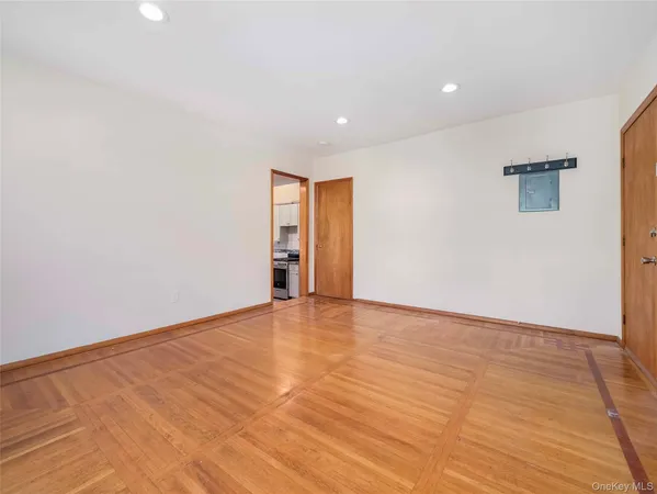 a view of an empty room with wooden floor