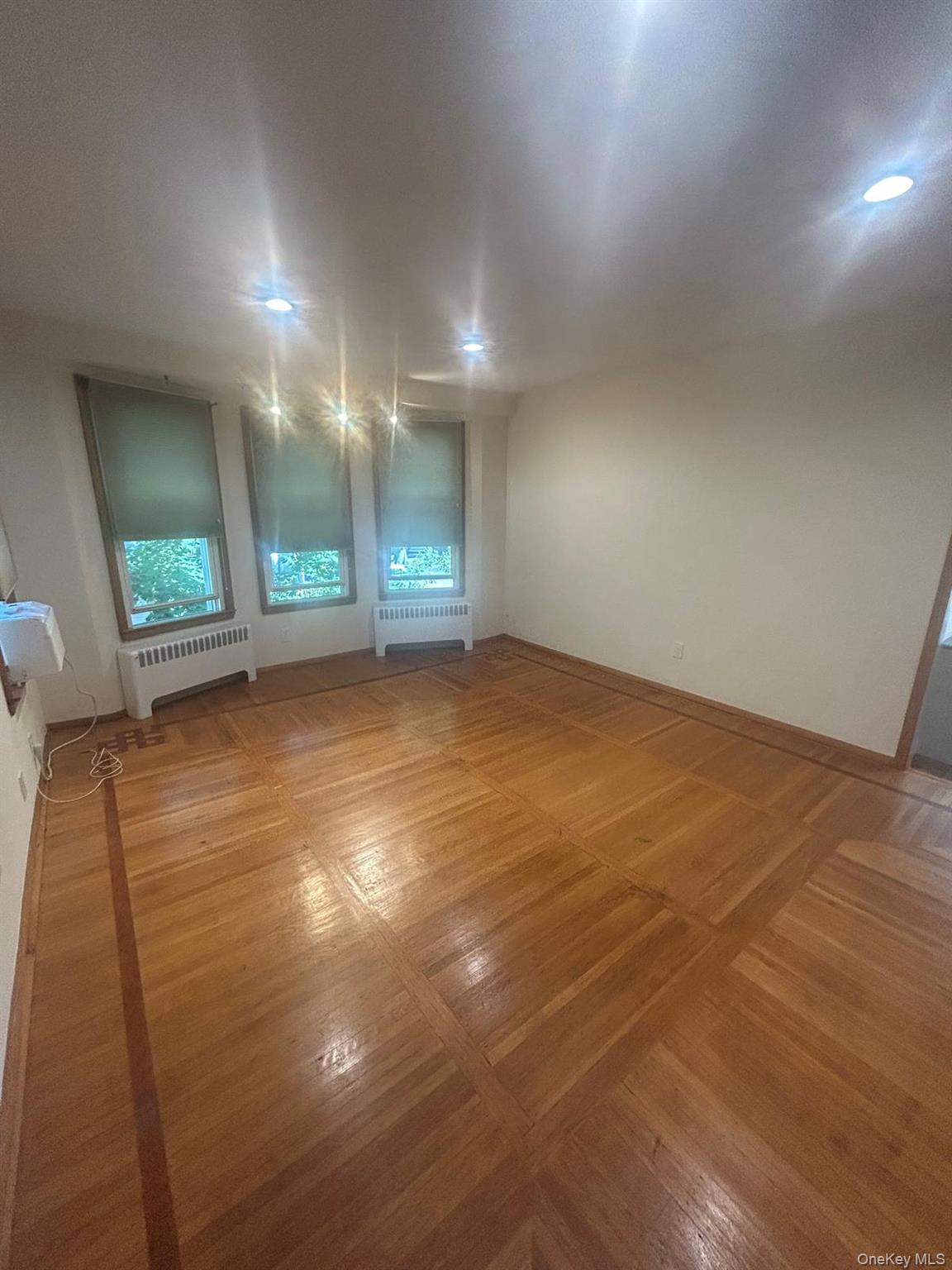 42 Park Avenue, Unit 3 Suffern, NY 10901 - Photo 9 of 13 an empty room with wooden floor and windows