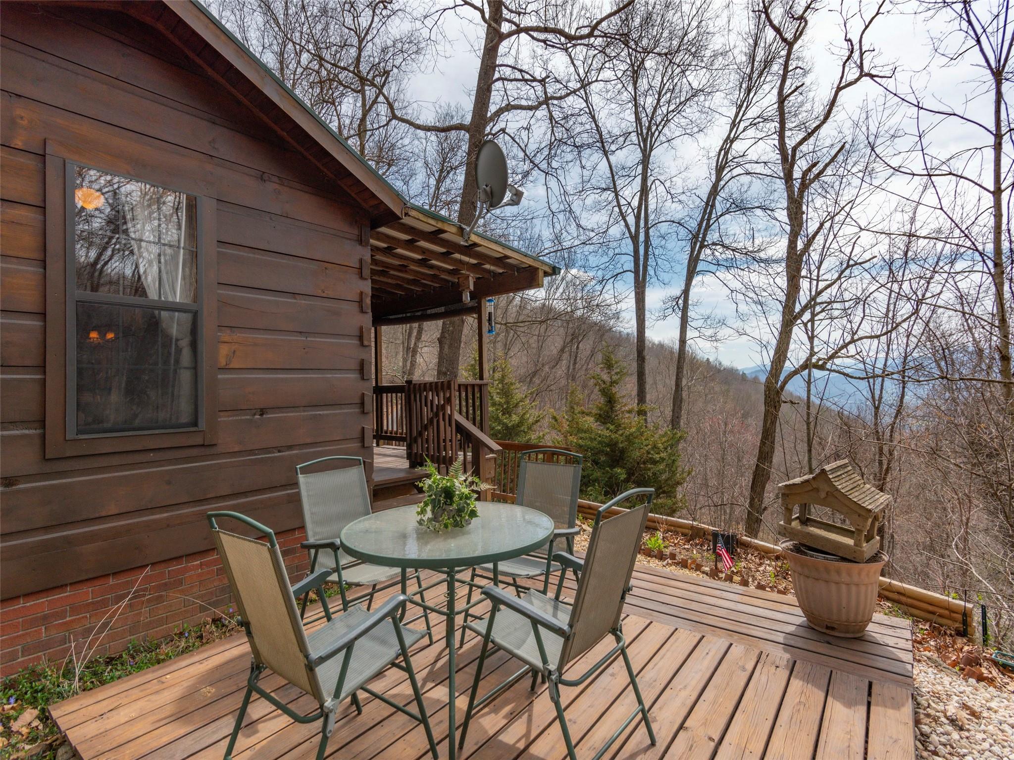 239 Sugar Hill Road Clyde, NC 28721 - Photo 2 of 20 a backyard of a house with table and chairs