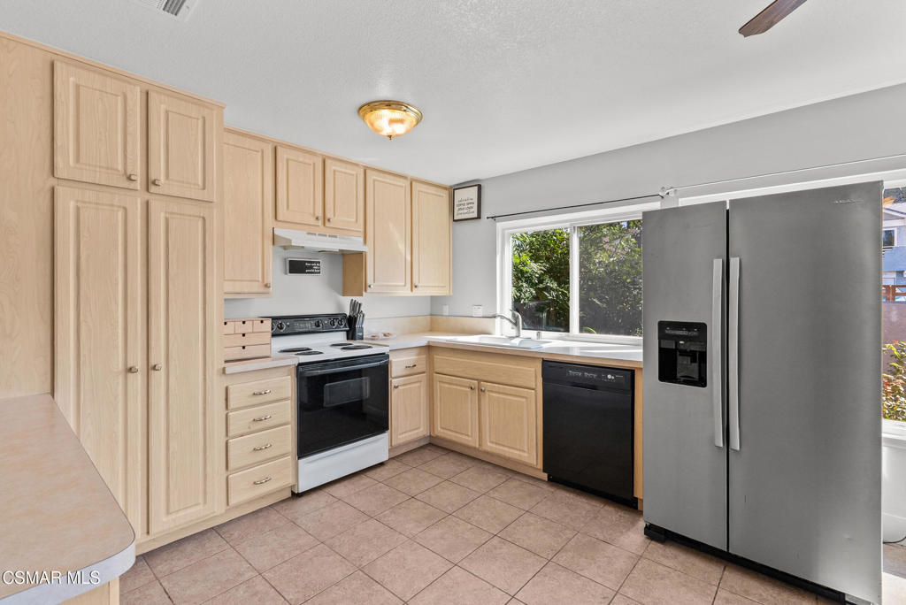 3998 Celia Court Simi Valley, CA 93063 - Photo 23 of 44 a kitchen with white cabinets and white appliances