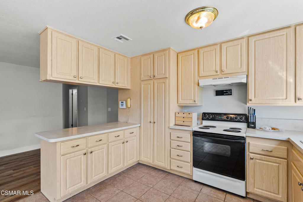 3998 Celia Court Simi Valley, CA 93063 - Photo 24 of 44 a kitchen with white cabinets and stainless steel appliances