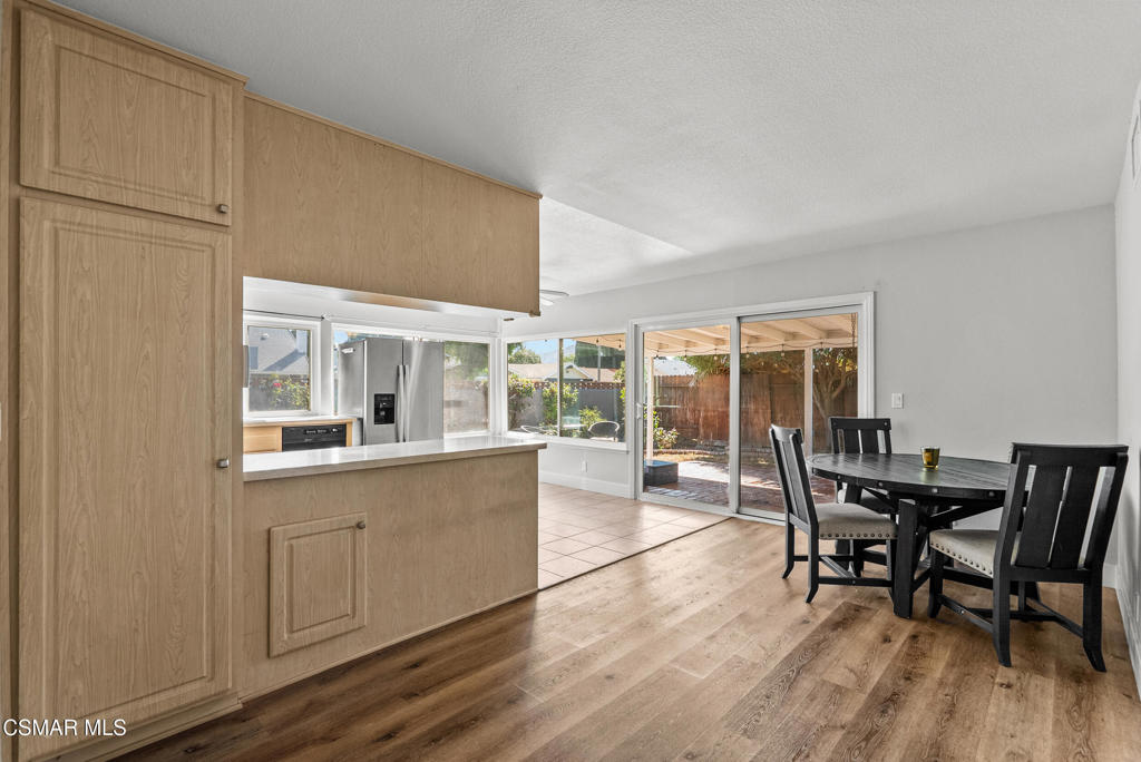 3998 Celia Court Simi Valley, CA 93063 - Photo 42 of 44 a dining room with wooden floor a glass table and chairs