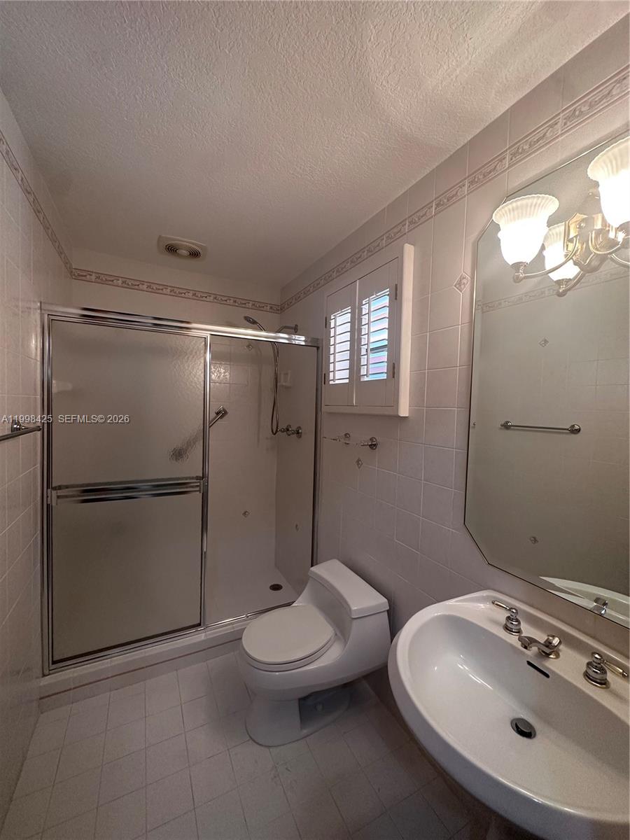 2980 Southwest 111th Avenue Miami, FL 33165 - Photo 13 of 39 a bathroom with a sin shower vanity and a toilet