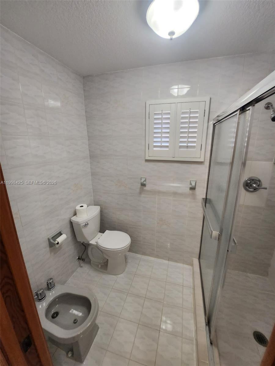 2980 Southwest 111th Avenue Miami, FL 33165 - Photo 20 of 39 a bathroom with a toilet and a shower