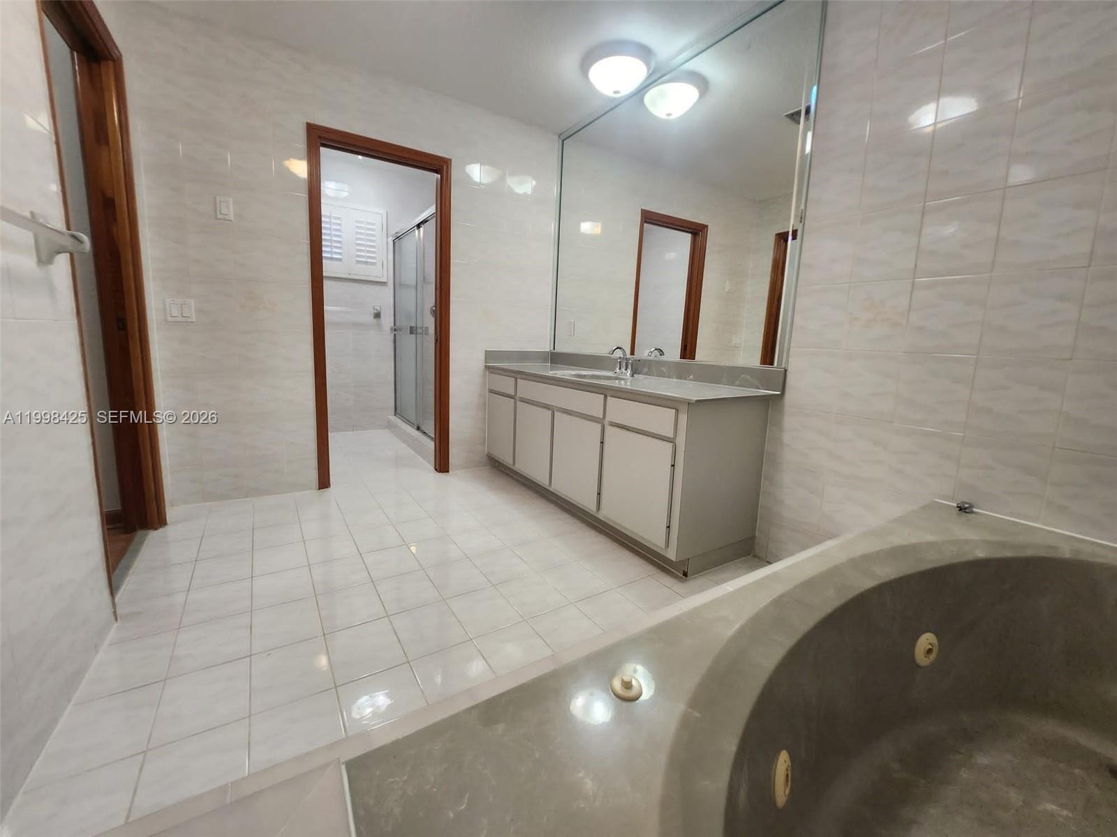 2980 Southwest 111th Avenue Miami, FL 33165 - Photo 21 of 39 a bathroom with a double vanity sink mirror and shower