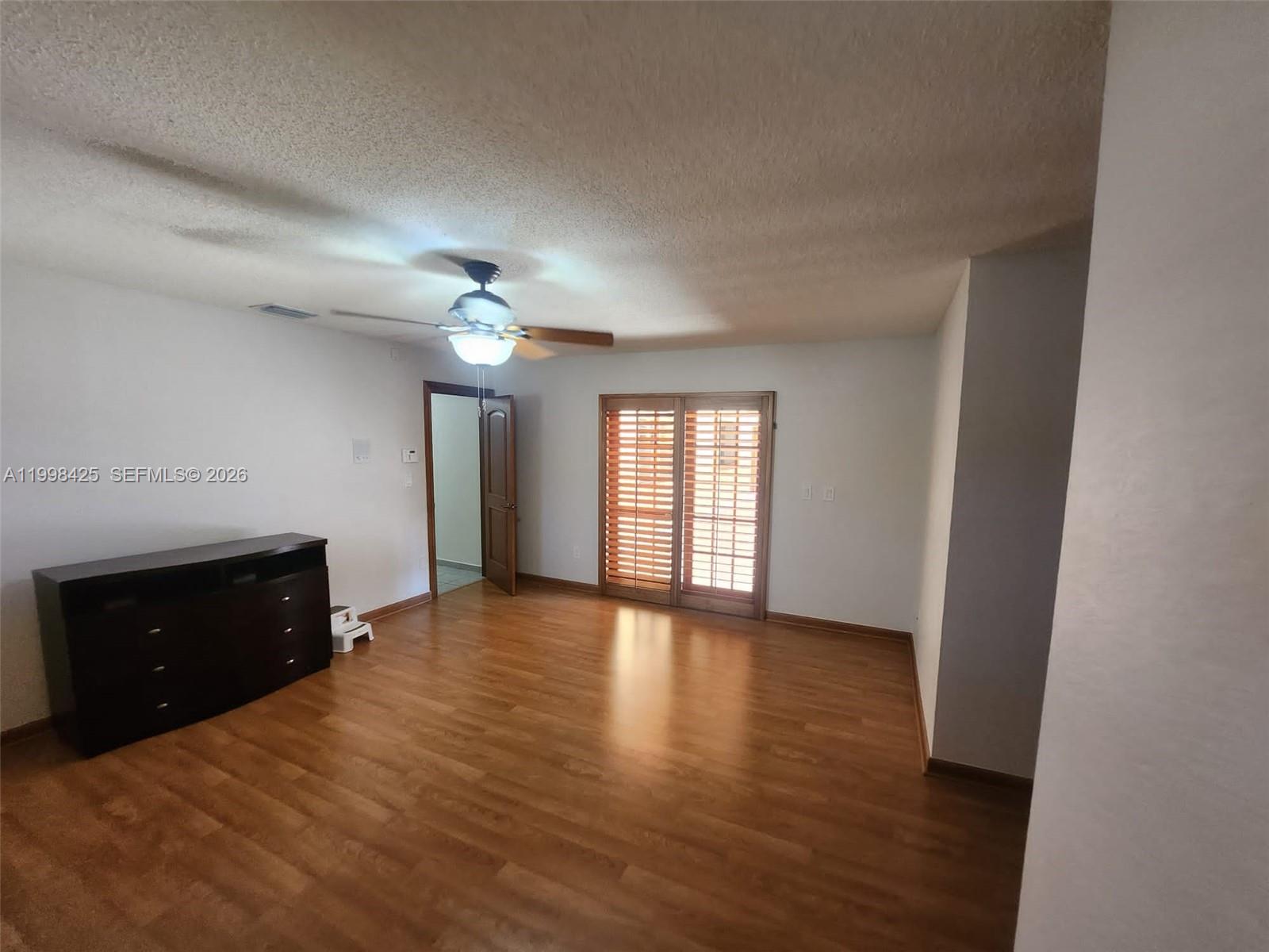 2980 Southwest 111th Avenue Miami, FL 33165 - Photo 22 of 39 a view of an empty room with a window and wooden floor
