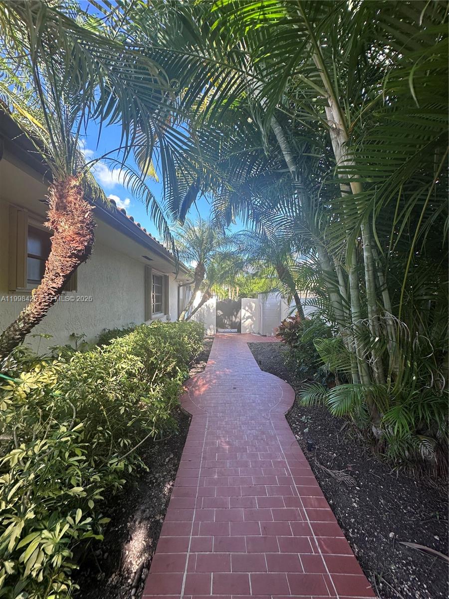 2980 Southwest 111th Avenue Miami, FL 33165 - Photo 28 of 39 a view of a pathway with a garden