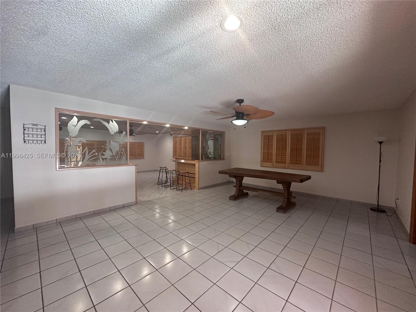 2980 Southwest 111th Avenue Miami, FL 33165 - Photo 9 of 39 an empty room with windows and fan