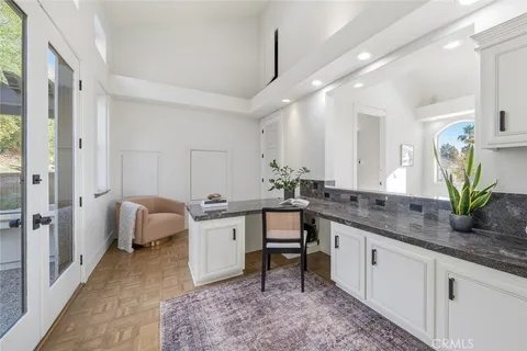 a kitchen with a sink cabinets and wooden floor