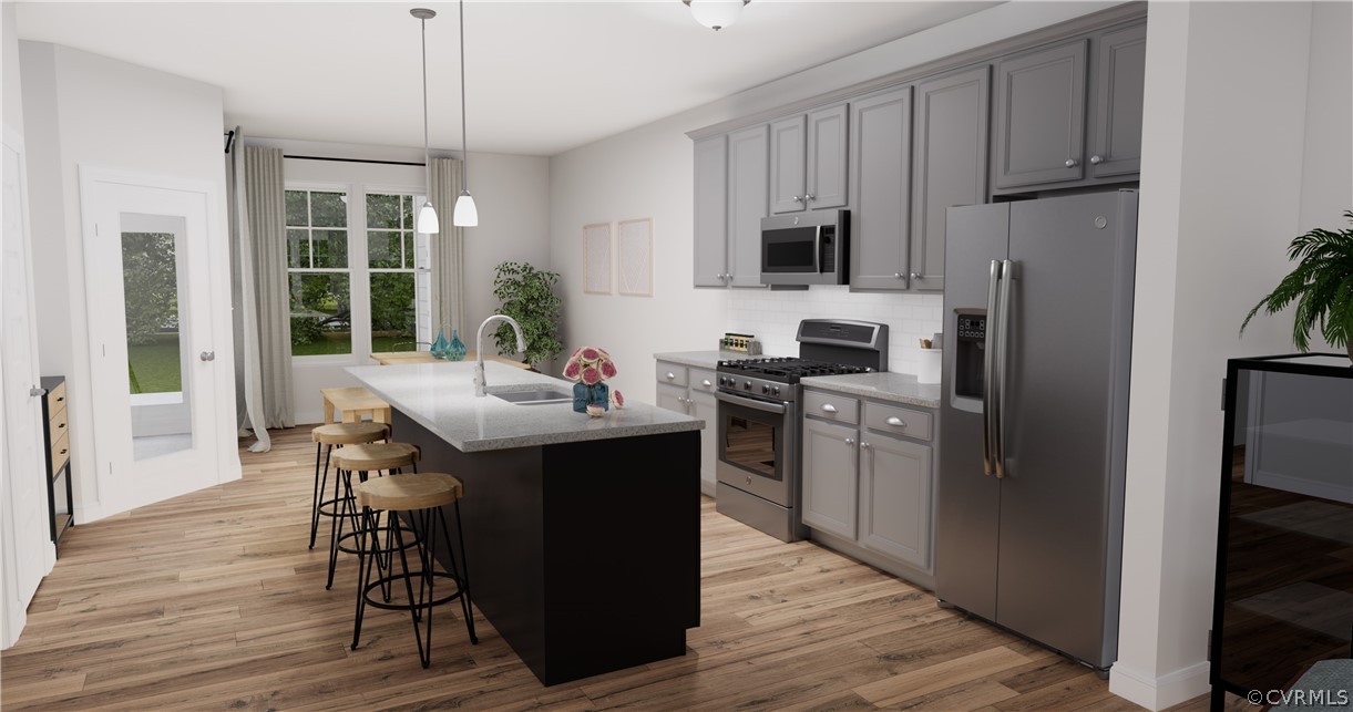 12208 Lightning Bug Loop Midlothian, VA 23112 - Photo 1 of 36 a kitchen with refrigerator cabinets and wooden floor