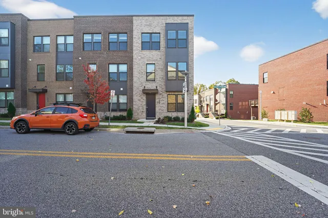 a couple of cars parked in front of a building
