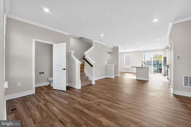 a view of a kitchen with wooden floor and a kitchen